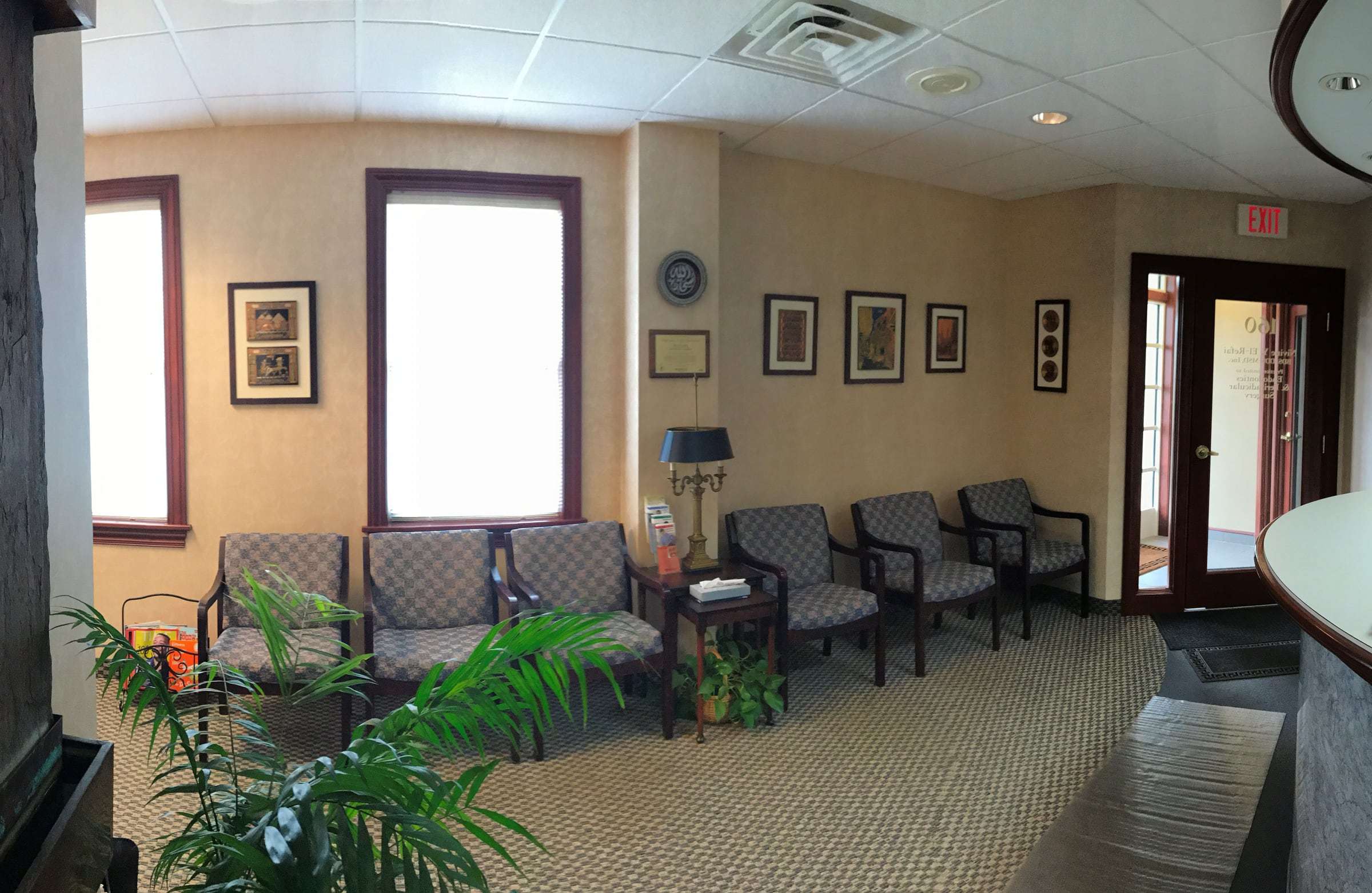 Our waiting room, with chairs along a sunny wall and framed art