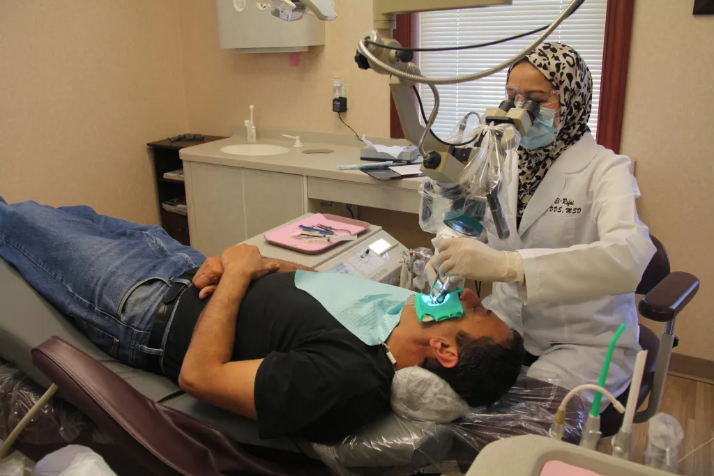 Dr. El-Refai with patient in dental chair