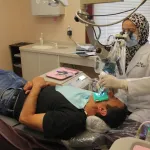 Dr. El-Refai with patient in dental chair