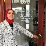 Dr. Nivine Y. El-Refai by the front door of the office