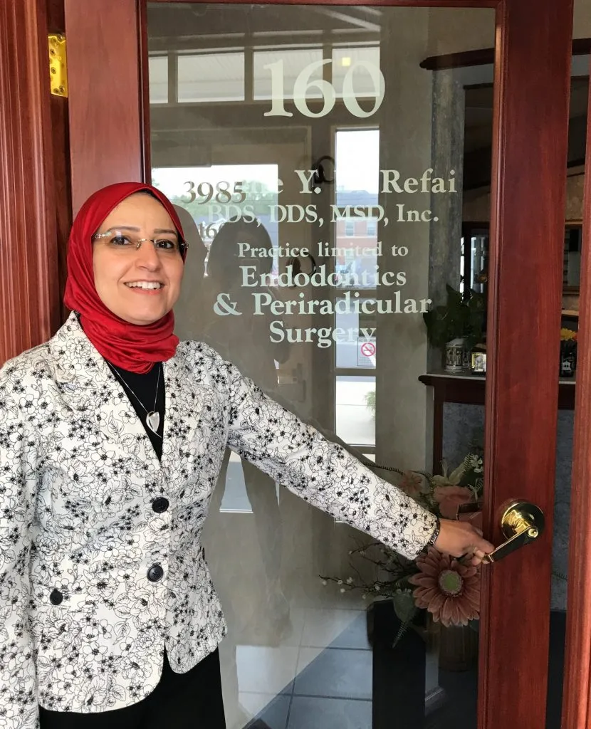 Dr. Nivine Y. El-Refai by the front door of the office